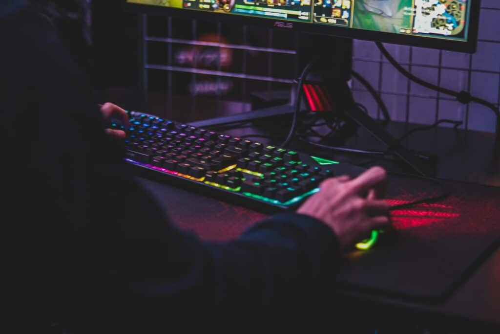 A gaming keyboard and mouse are being used by someone out of frame as they play a game, checking your game before you stream is important!