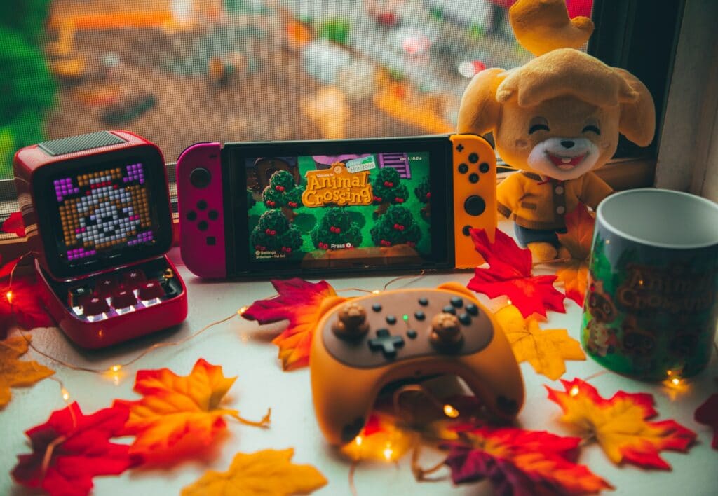 A Nintendo Switch on a desk playing Animal Crossing with plushies around which could be one of the best games to stream.