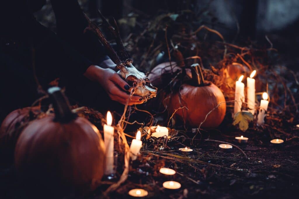 Pumpkins on the ground with a woman holding a skull spooky webcam backgrounds