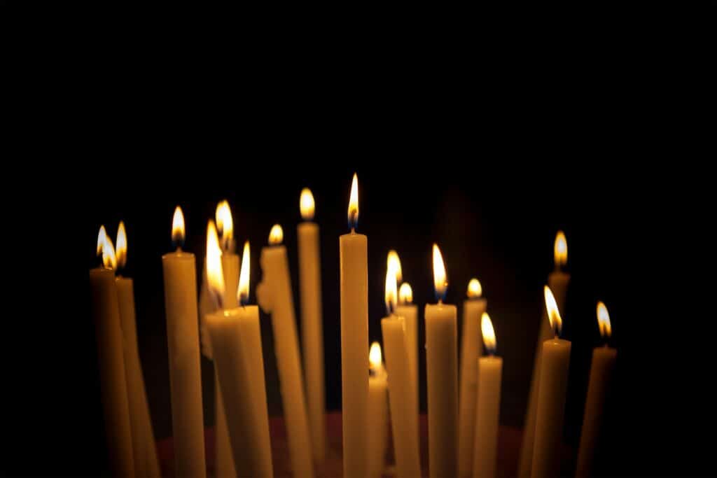Many candles in a dark room spooky webcam background.