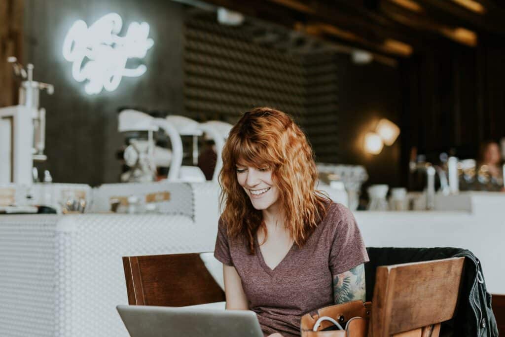 A person using a laptop in a public space is a place to consider your online privacy.