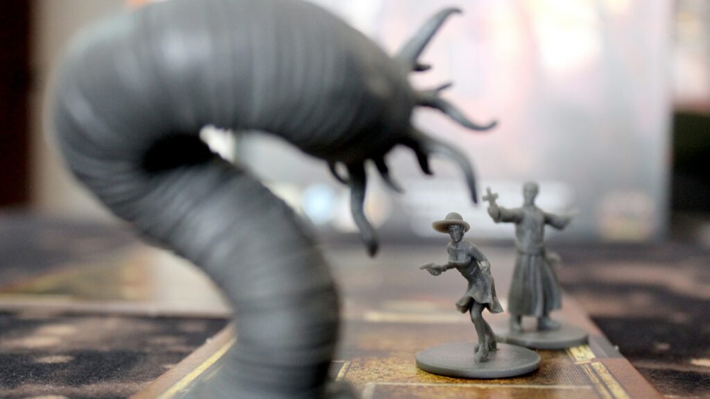 A close up of some miniature figures and a monster on a tabletop, things you might need to stream Dungeons and Dragons