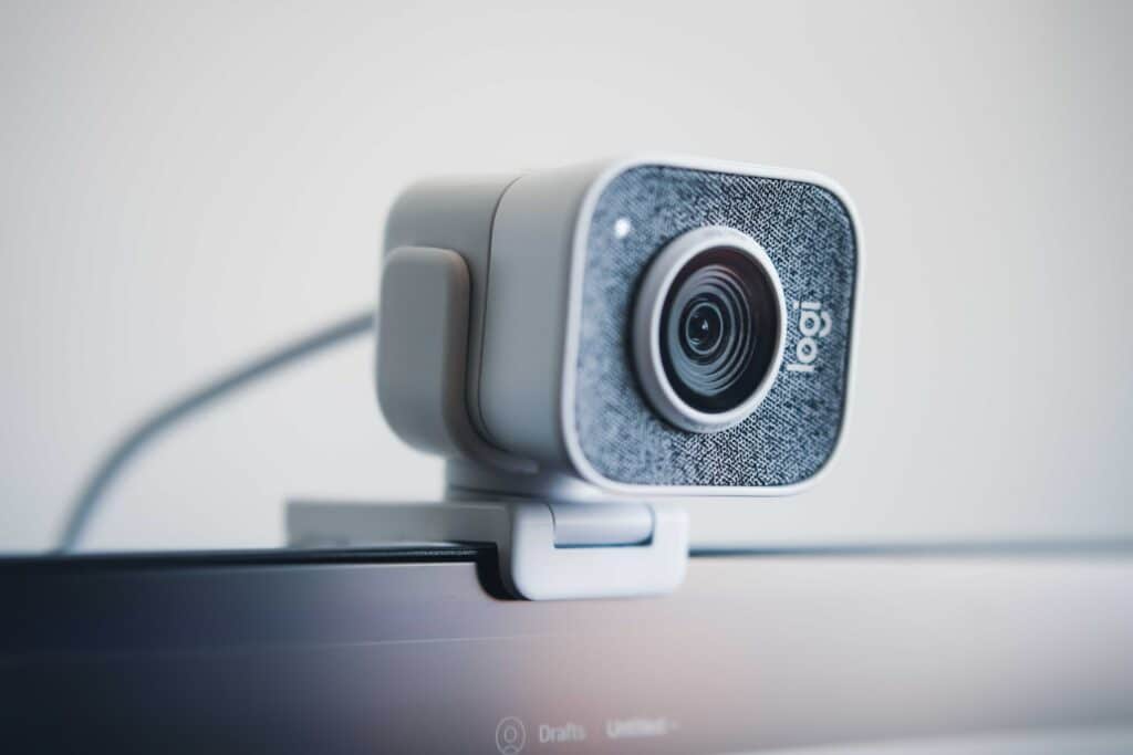 An image of a Logitech StreamCam sat on top of a PC monitor which we recommend as an option for how to stream games.