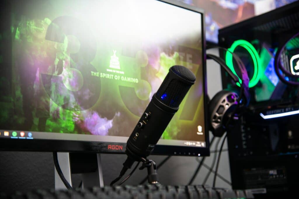 A gaming PC setup with a microphone front and centre, a higher end PC could imrpove your stream quality.