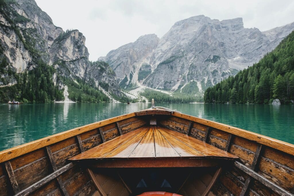 A view from a boat looking at a lake and some mountains