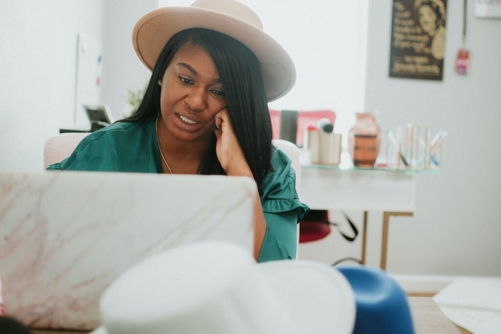 A remote team manager with an amazing hat at work from home.