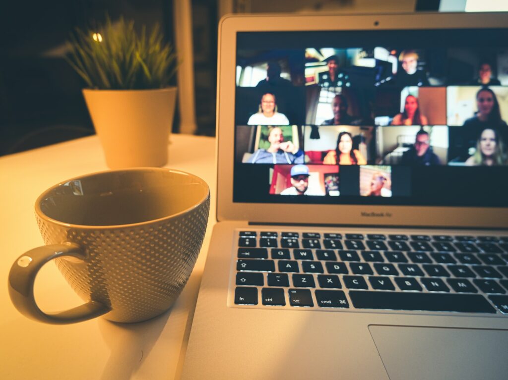 Work friends on a Zoom call together on a laptop in a work from home office